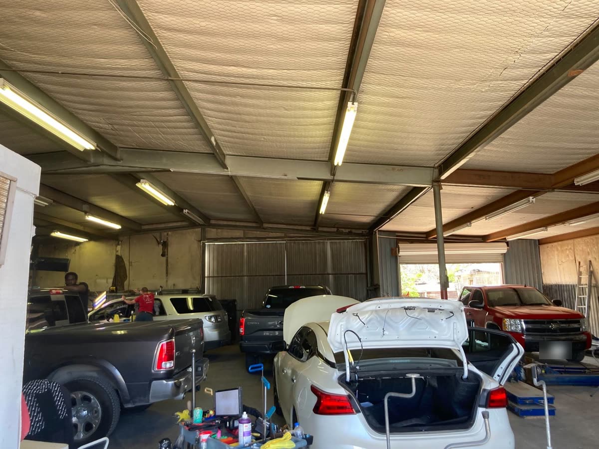 Inside the Dent Da Vinci shop: technicians repairing trucks and cars in the service bays
